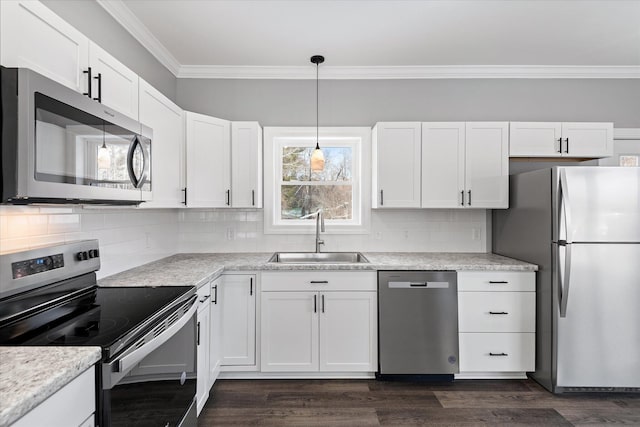 kitchen with white cabinetry, appliances with stainless steel finishes, sink, and pendant lighting