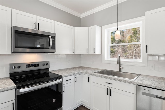 kitchen featuring white cabinetry, appliances with stainless steel finishes, sink, and crown molding