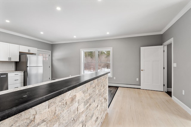 kitchen with light hardwood / wood-style flooring, baseboard heating, white cabinetry, stainless steel appliances, and ornamental molding