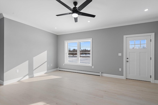 foyer entrance featuring baseboard heating, ornamental molding, and light hardwood / wood-style floors