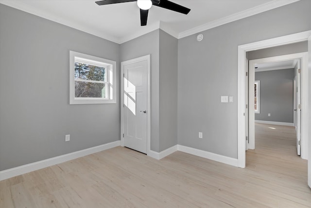 empty room featuring ornamental molding, ceiling fan, and light wood-type flooring