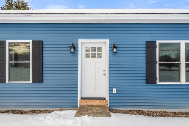 view of snow covered property entrance