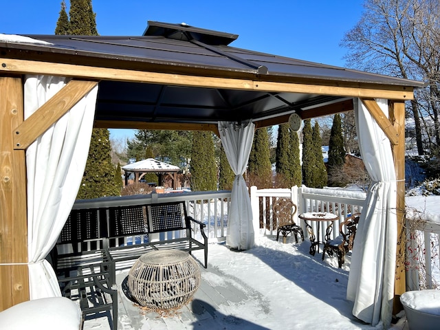 snow covered patio featuring a gazebo