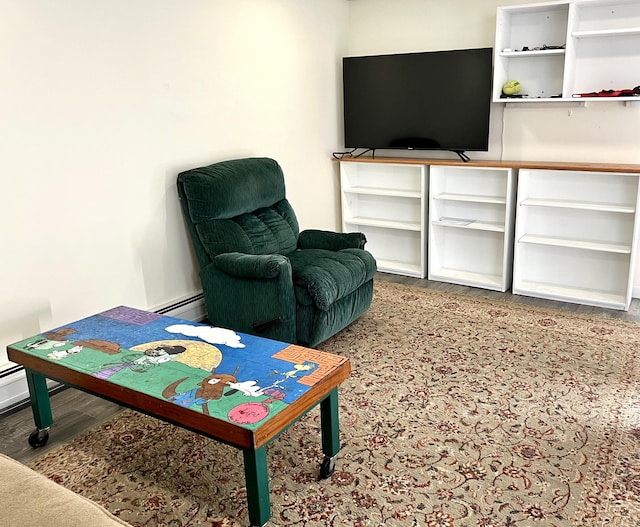 living room with hardwood / wood-style floors and a baseboard heating unit