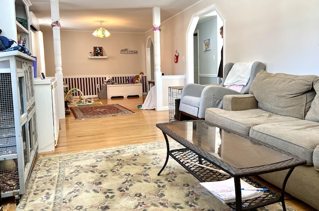 living room with crown molding and wood-type flooring