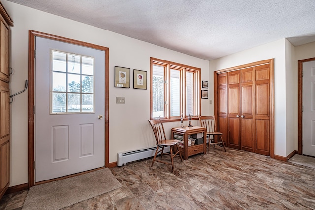 foyer featuring a baseboard radiator, baseboards, and a textured ceiling