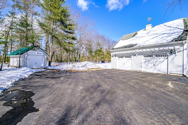 exterior space with an outbuilding and a detached garage