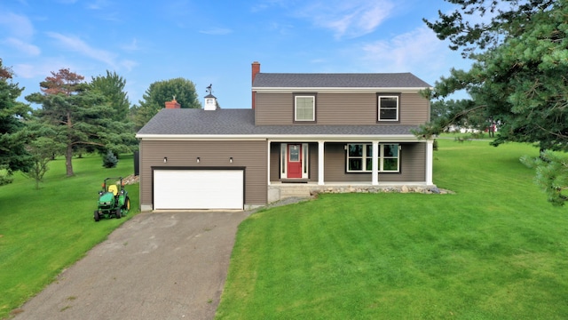 view of front facade with a garage, a front yard, and covered porch