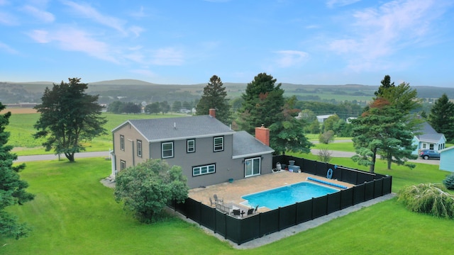 28 Grendell Rd, Mapleton, ME 04757 - back of house featuring a fenced in pool, a patio, a mountain view, and a yard