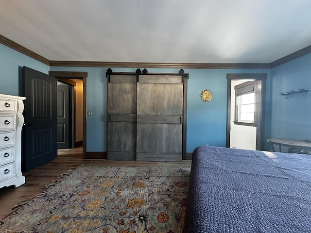 28 Grendell Rd, Mapleton, ME 04757 - bedroom with crown molding, dark wood-type flooring, and a barn door