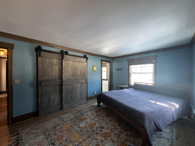28 Grendell Rd, Mapleton, ME 04757 - bedroom with hardwood / wood-style flooring, ornamental molding, and a barn door