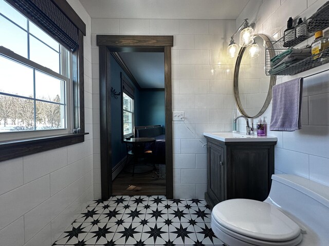 28 Grendell Rd, Mapleton, ME 04757 - bathroom featuring vanity, tile walls, and toilet