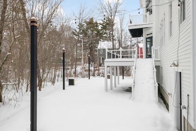 snowy yard featuring a playground