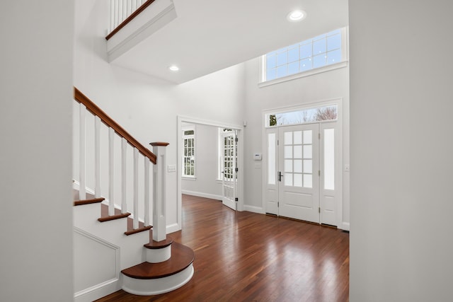 foyer featuring stairs, recessed lighting, dark wood finished floors, and baseboards