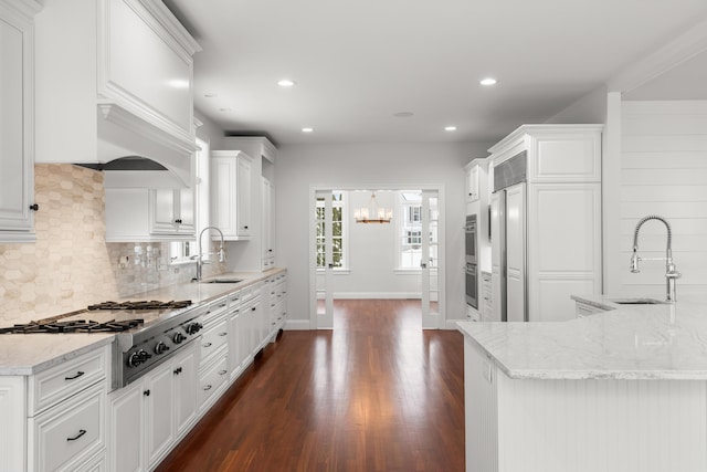 kitchen featuring stainless steel gas stovetop, white cabinetry, and a sink