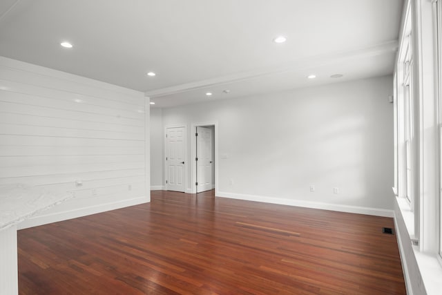 empty room with baseboards, dark wood finished floors, visible vents, and recessed lighting