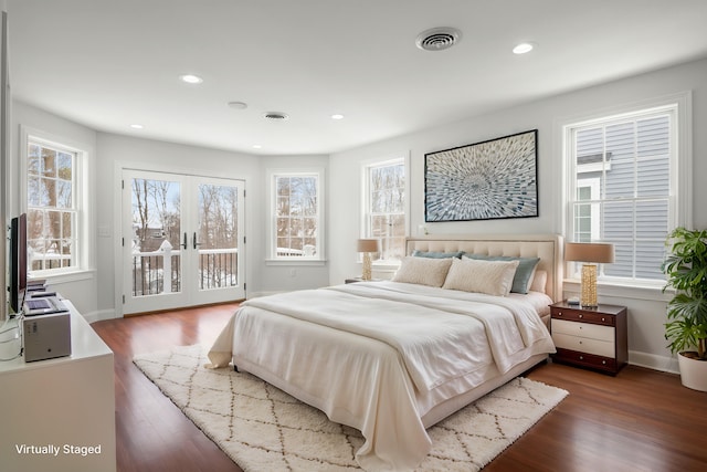 bedroom featuring access to outside, visible vents, dark wood-style flooring, and french doors