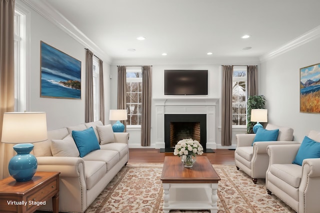 living area with light wood finished floors, a fireplace, recessed lighting, and crown molding