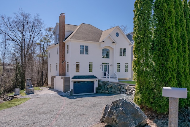 8 Harrison Ave, York, ME 03909 - view of front of home featuring driveway, a garage, and a chimney