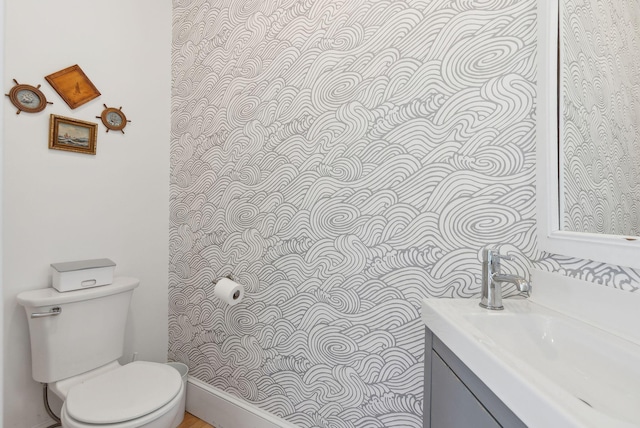 bathroom with toilet and vanity