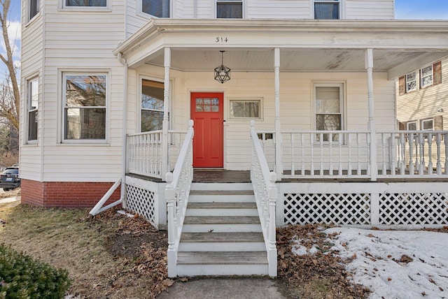 view of exterior entry featuring a porch