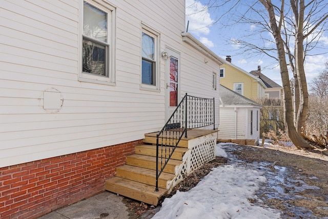 view of snow covered property entrance