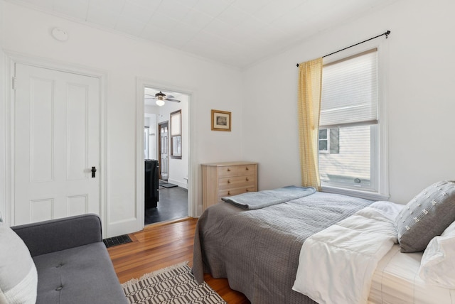 bedroom featuring connected bathroom and wood finished floors