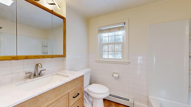 bathroom with toilet, tile walls, ornamental molding, vanity, and a baseboard heating unit