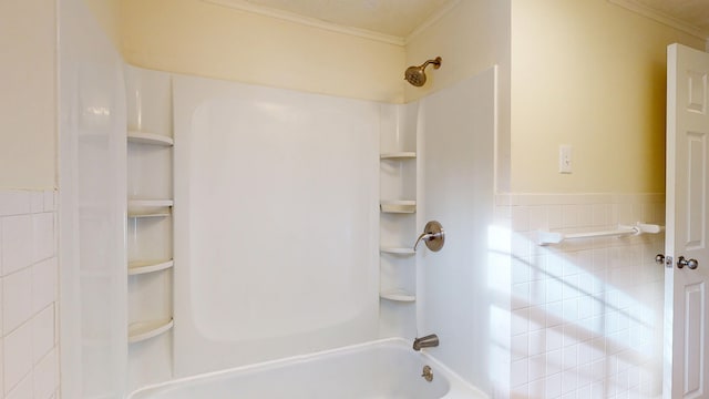 bathroom featuring ornamental molding and shower / washtub combination