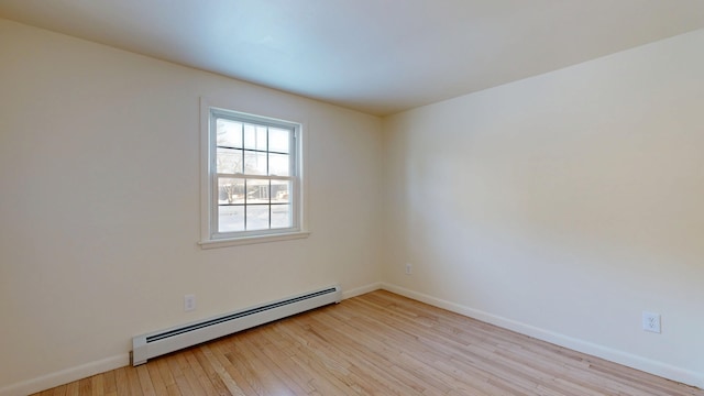 empty room featuring light hardwood / wood-style floors and baseboard heating