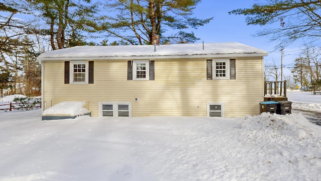 view of snow covered back of property