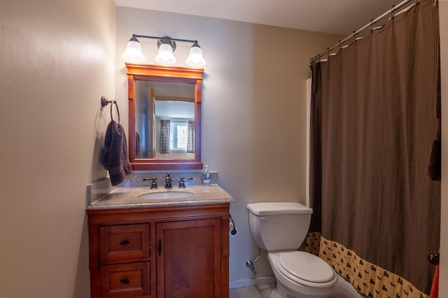 bathroom featuring vanity, toilet, and a shower with shower curtain