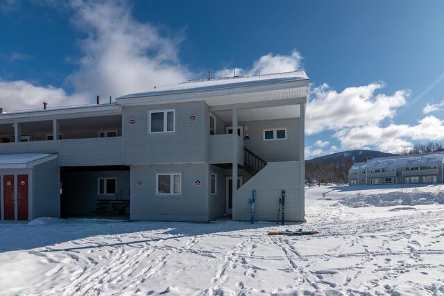 snow covered house with a mountain view