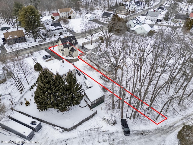 snowy aerial view with a residential view