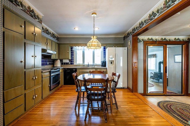 kitchen featuring black dishwasher, sink, white fridge with ice dispenser, stainless steel range, and light wood-type flooring