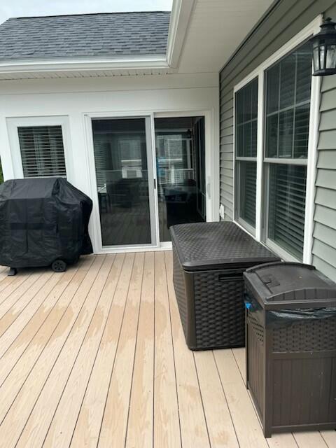 wooden deck with a grill