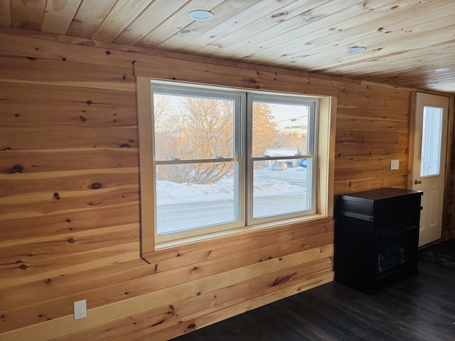 additional living space featuring wooden ceiling, dark hardwood / wood-style floors, and wood walls