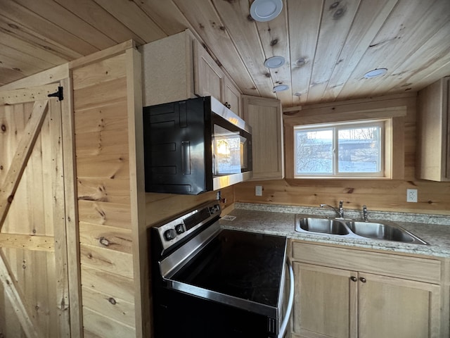 kitchen with light brown cabinetry, sink, wood walls, wooden ceiling, and stainless steel appliances