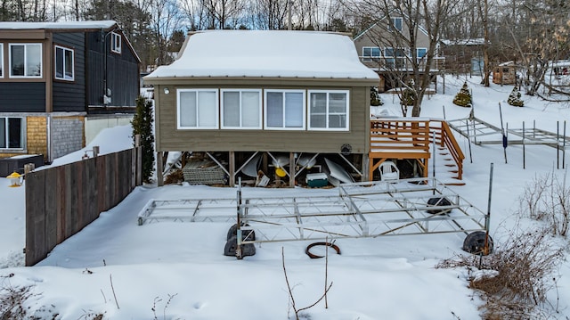 view of snow covered rear of property