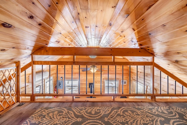 additional living space featuring wood ceiling, hardwood / wood-style flooring, and wooden walls