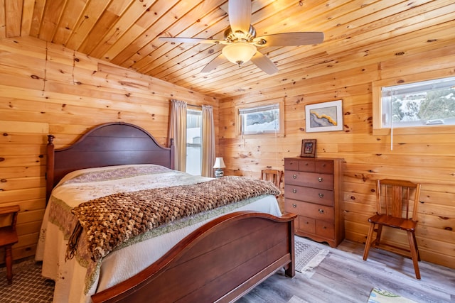 bedroom featuring wood ceiling, wooden walls, and wood-type flooring