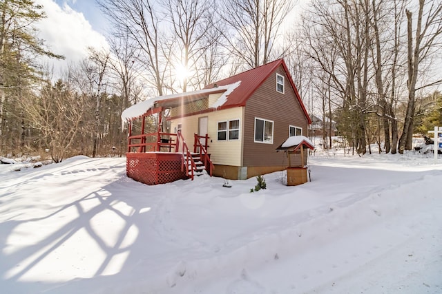 view of snow covered exterior featuring a deck