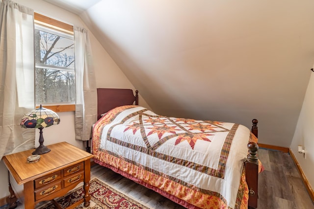 bedroom featuring vaulted ceiling and dark hardwood / wood-style floors