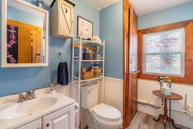 bathroom with vanity, hardwood / wood-style flooring, and toilet