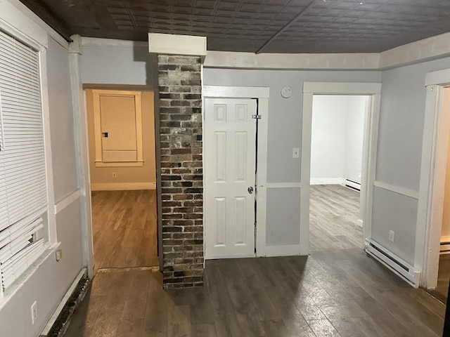 hallway with dark hardwood / wood-style flooring and a baseboard heating unit