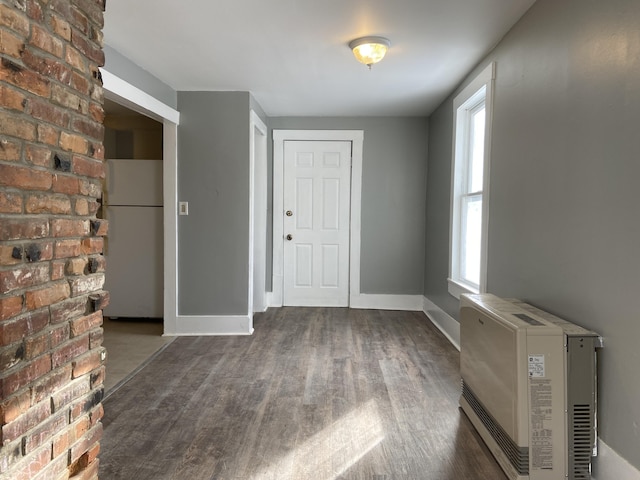 foyer featuring heating unit and dark hardwood / wood-style flooring