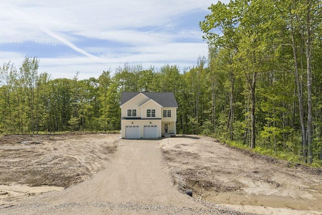 42 Jasper Ln, Arundel, ME 04046 - view of front of home featuring driveway, a garage, and a view of trees