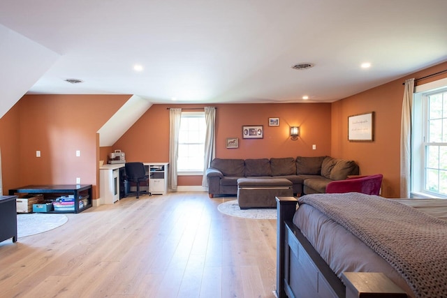 bedroom featuring multiple windows and light hardwood / wood-style flooring