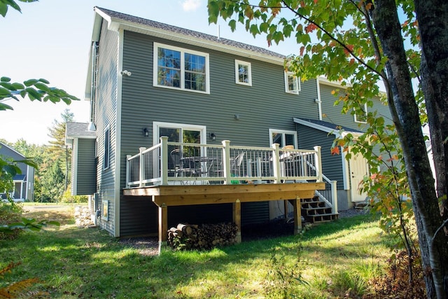 rear view of house featuring a yard and a deck