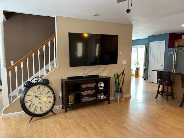 living room featuring ceiling fan and light wood-type flooring